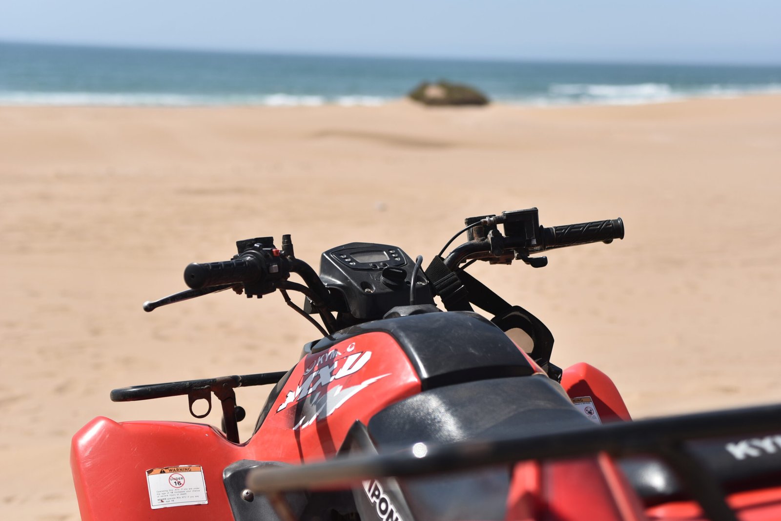 Tourist taking a break during a Quad Biking Agadir tour in the desert dunes